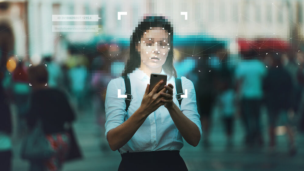 A woman scanning her face with a smartphone